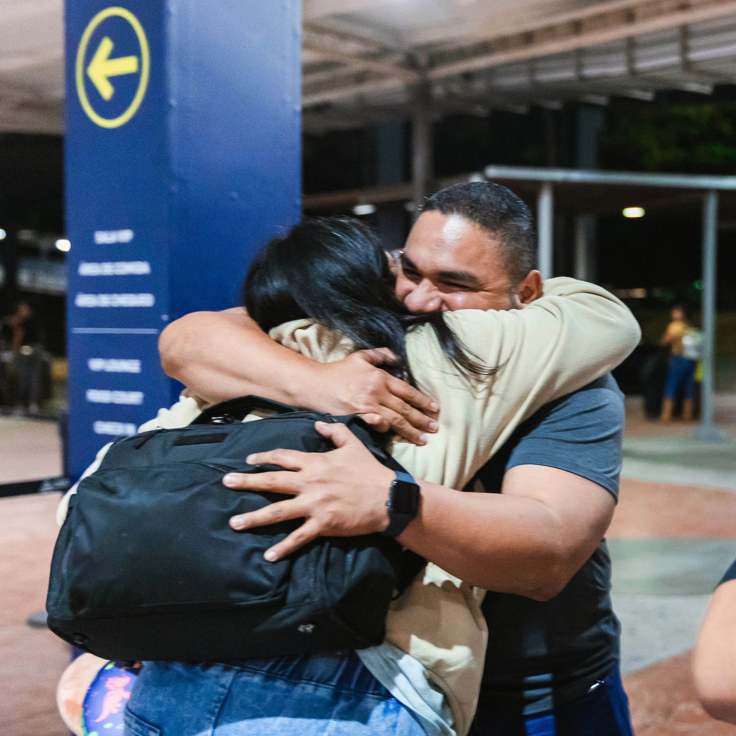 Happy travelers arriving together at the airport